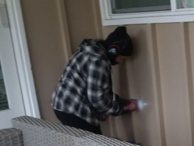 Professional electrician installing an exterior outlet in Forestville